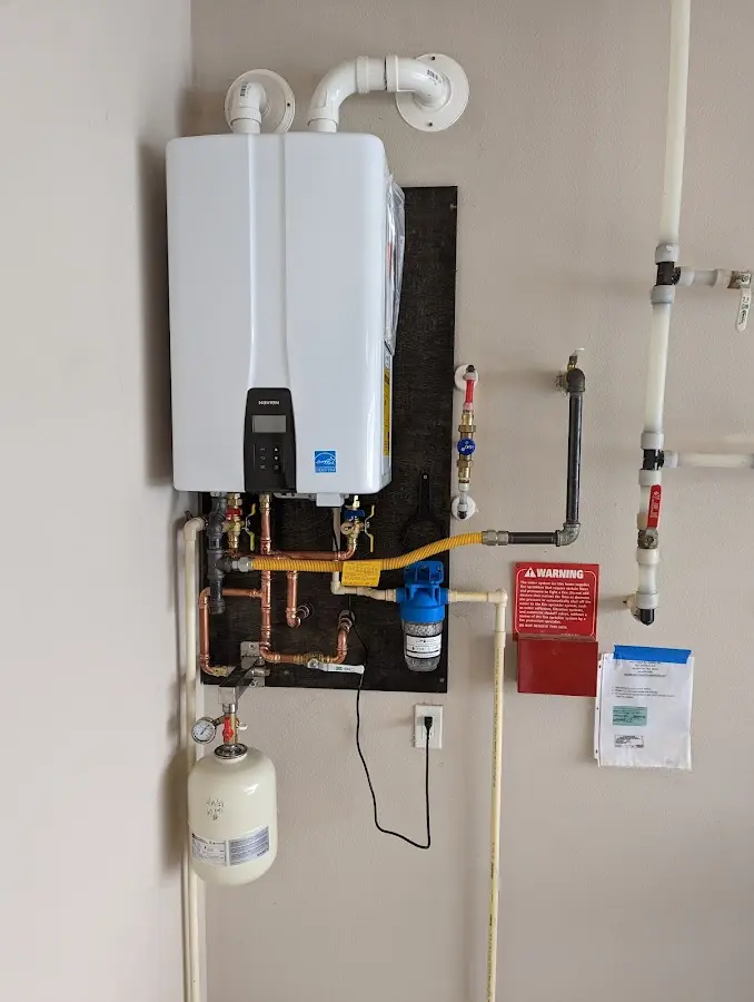 Professional plumber installing copper piping in a Jasper home